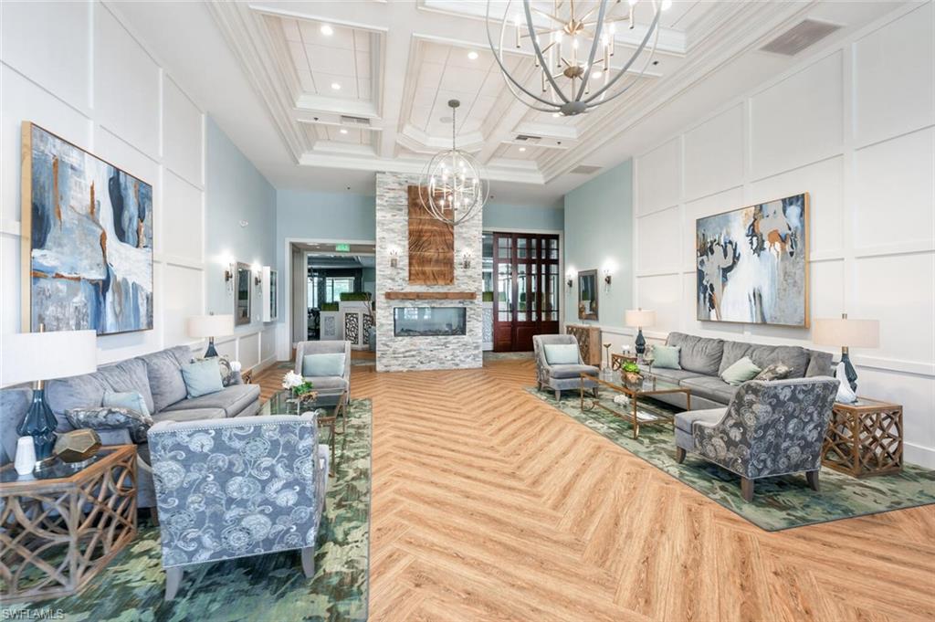 8600 Cedar Hammock Circle, Unit 1313 Naples, FL 34112 - Photo 30 of 48 a living room with furniture and a chandelier