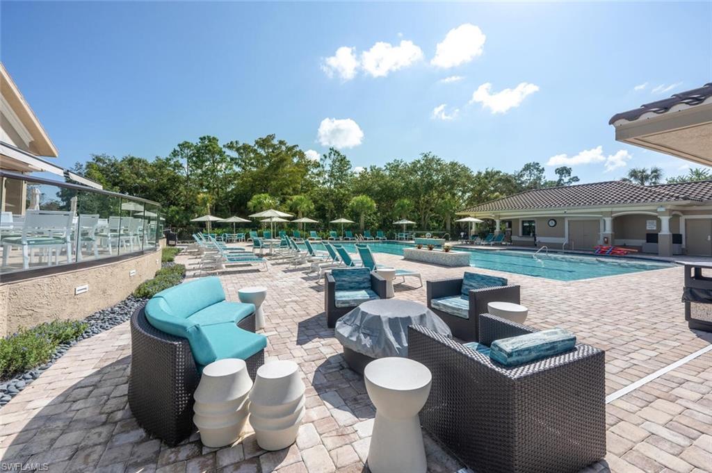 8600 Cedar Hammock Circle, Unit 1313 Naples, FL 34112 - Photo 37 of 48 a view of a patio with couches table and chairs and potted plants