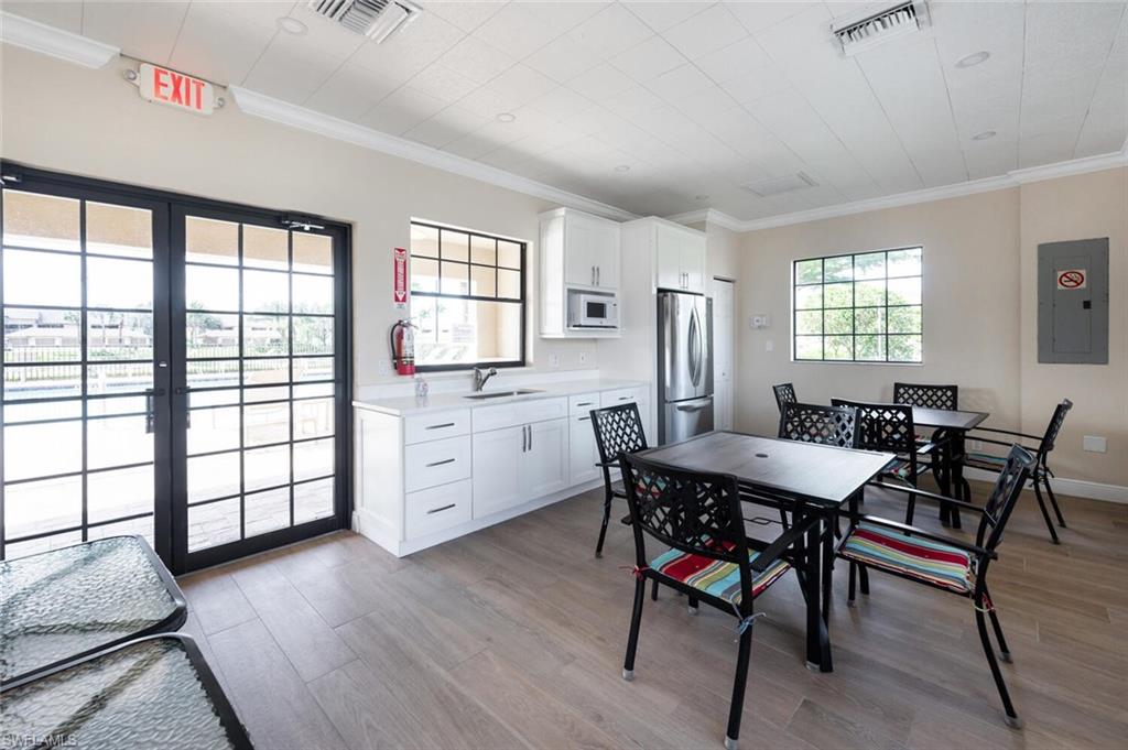 8600 Cedar Hammock Circle, Unit 1313 Naples, FL 34112 - Photo 41 of 48 a view of a dining room with furniture and window
