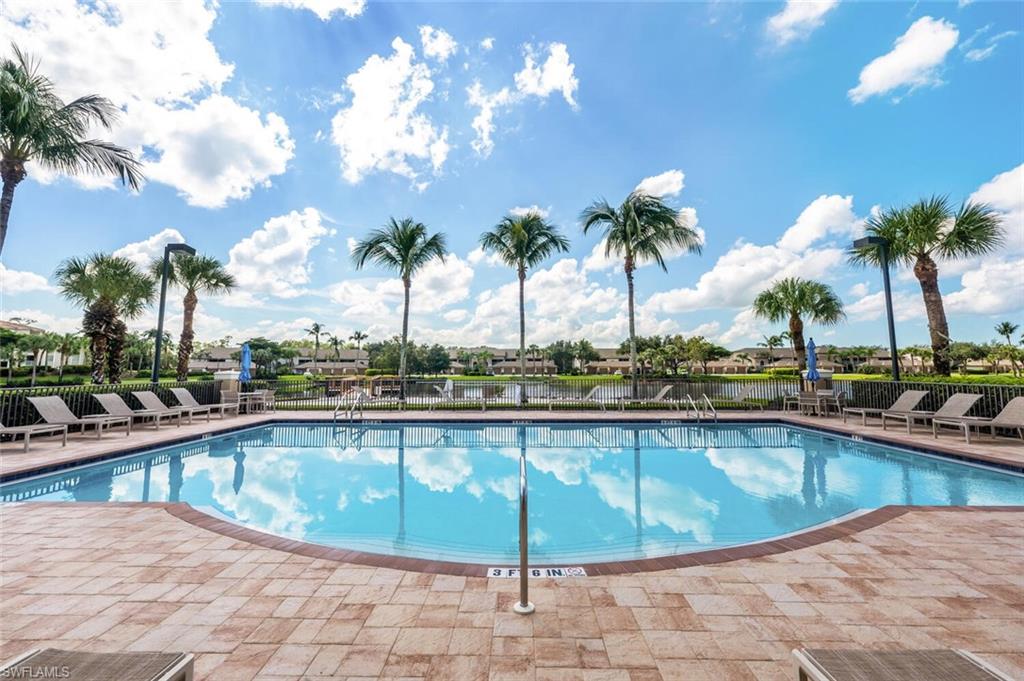 8600 Cedar Hammock Circle, Unit 1313 Naples, FL 34112 - Photo 42 of 48 a view of a swimming pool with a lounge chair