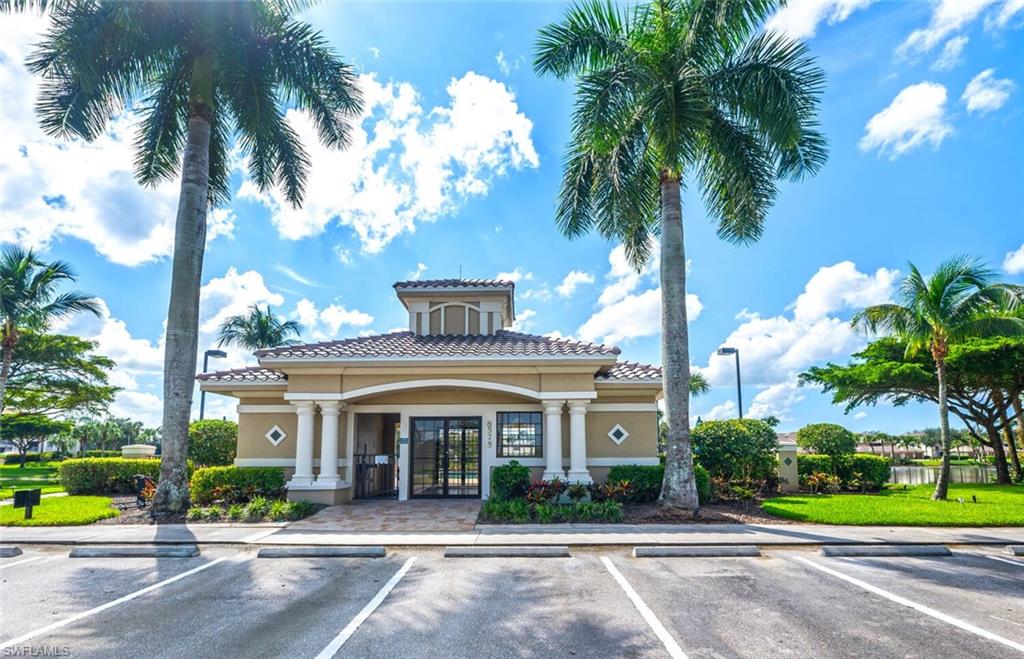 8600 Cedar Hammock Circle, Unit 1313 Naples, FL 34112 - Photo 43 of 48 a front view of multi story residential apartment building with yard and green space