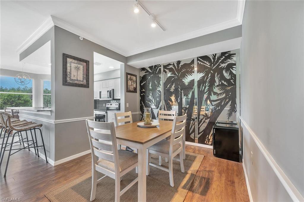 8600 Cedar Hammock Circle, Unit 1313 Naples, FL 34112 - Photo 9 of 48 a view of a dining room with furniture and wooden floor