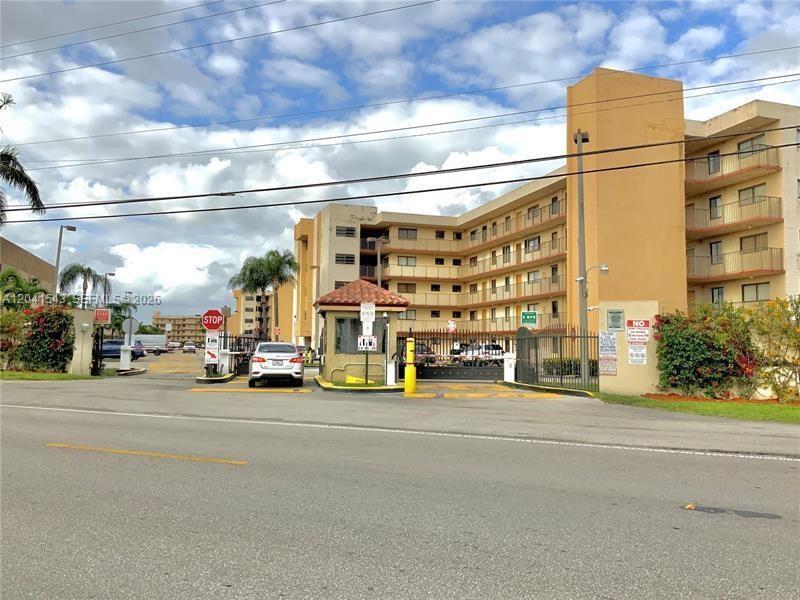 9915 West Okeechobee Road, Unit 2404 Hialeah Gardens, FL 33016 - Photo 2 of 5 a view of a street with cars