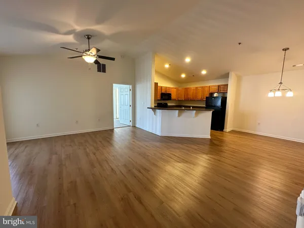 a view of a kitchen with a sink and dishwasher a oven with wooden floor