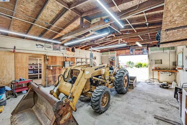 a view of a big house with a big yard and large tree