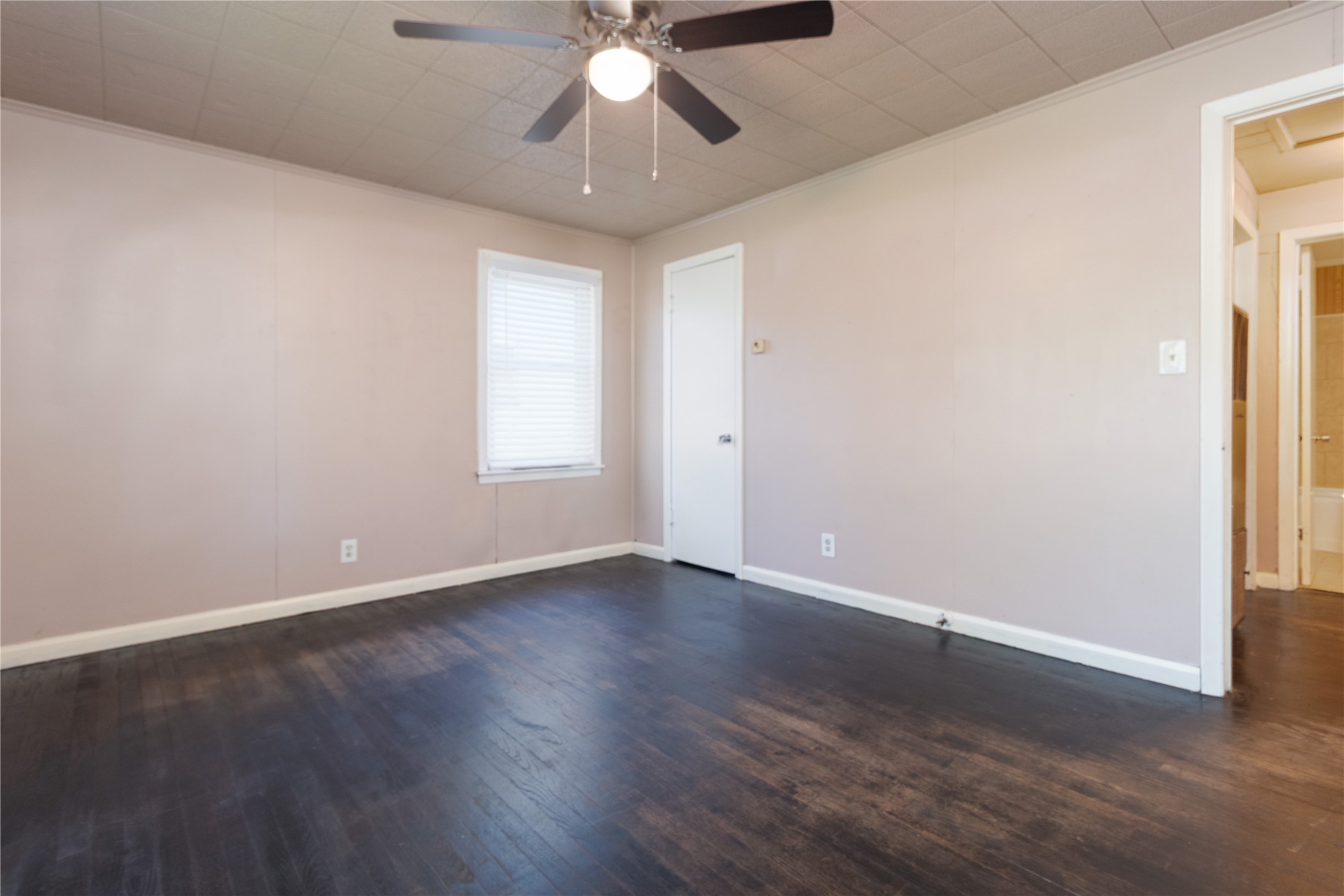 4425 Harding Drive Beaumont, TX 77703 - Photo 12 of 25 an empty room with wooden floor fan and windows