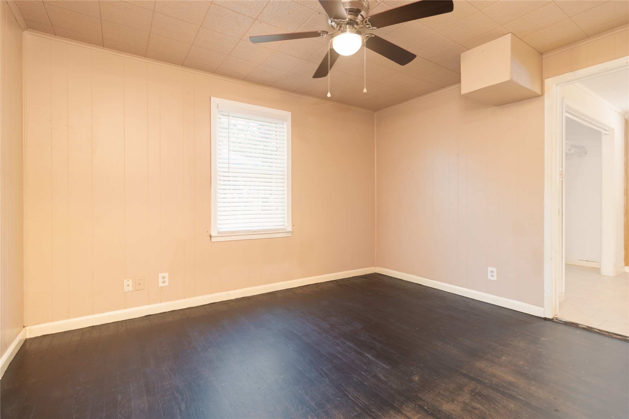 4425 Harding Drive Beaumont, TX 77703 - Photo 15 of 25 an empty room with wooden floor fan and windows