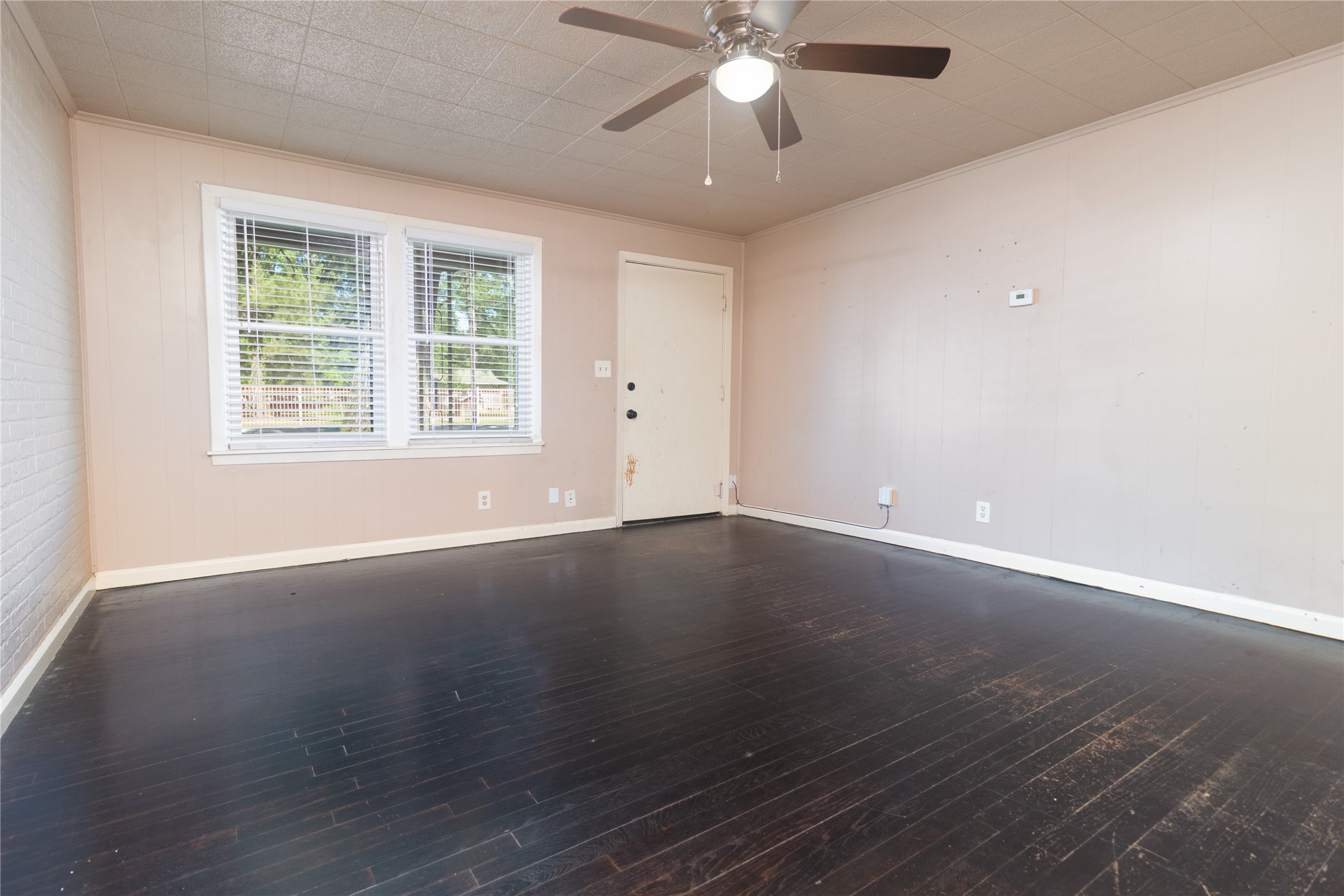 4425 Harding Drive Beaumont, TX 77703 - Photo 4 of 25 an empty room with wooden floor and windows