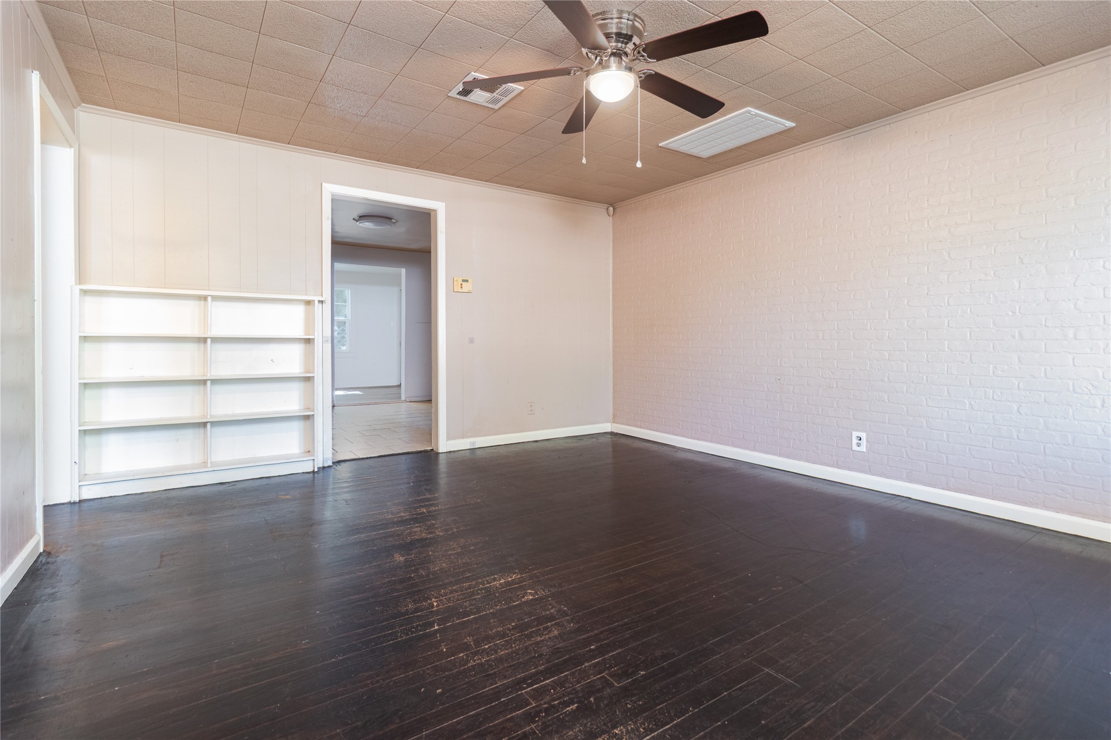 4425 Harding Drive Beaumont, TX 77703 - Photo 5 of 25 an empty room with wooden floor chandelier fan and windows