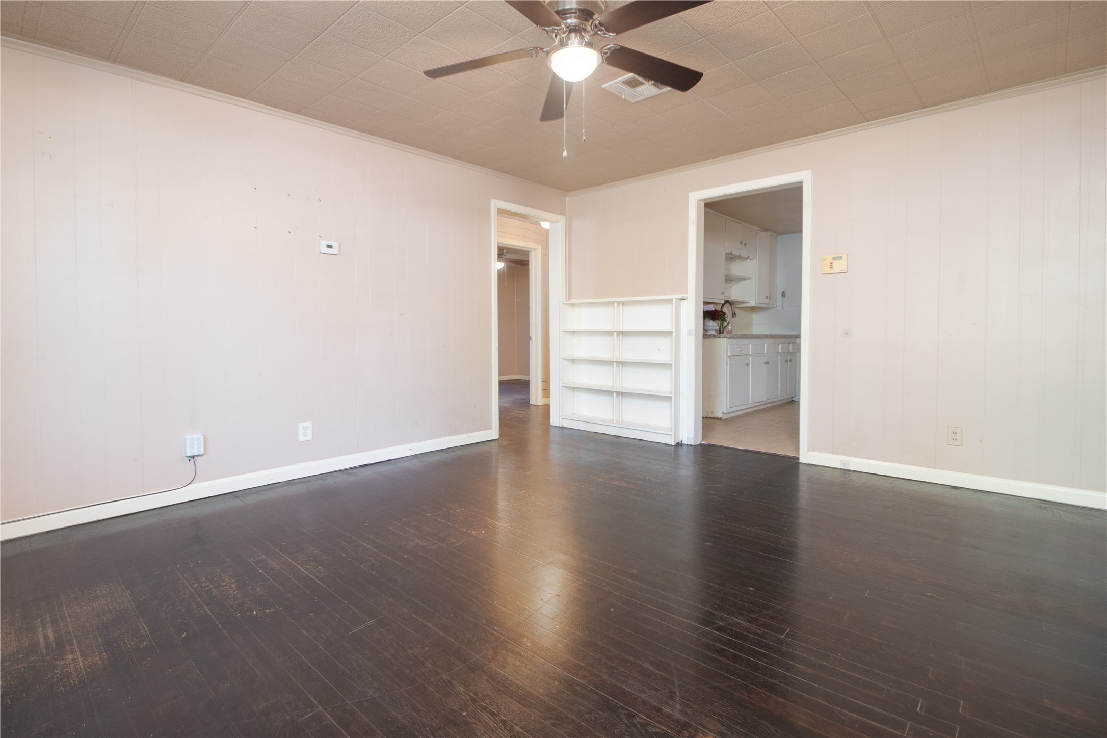 4425 Harding Drive Beaumont, TX 77703 - Photo 6 of 25 an empty room with wooden floor fan and windows