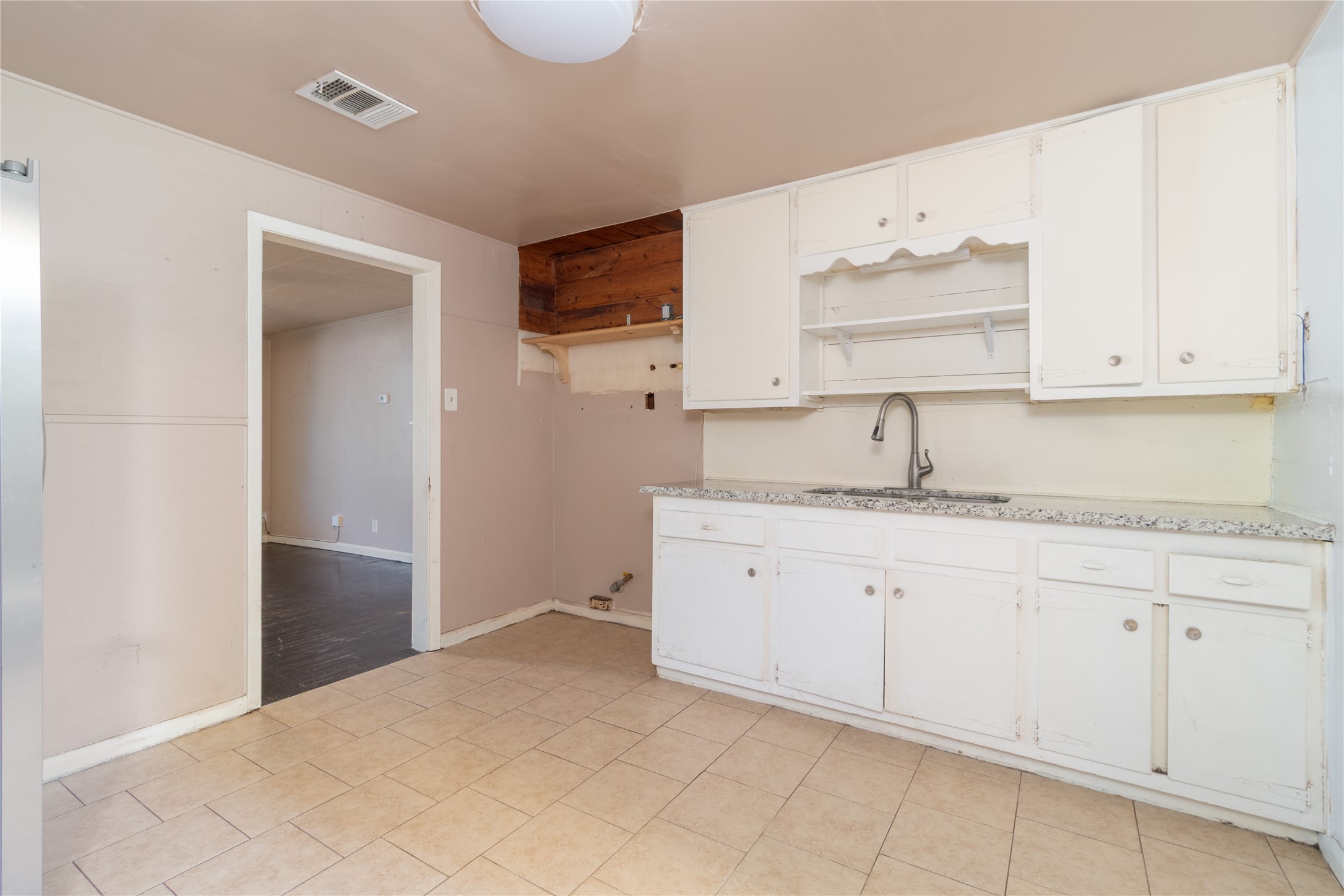 4425 Harding Drive Beaumont, TX 77703 - Photo 7 of 25 a kitchen with granite countertop white cabinets and sink