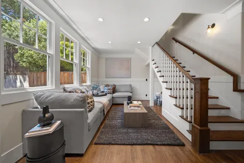 a living room with furniture couches and a view of kitchen