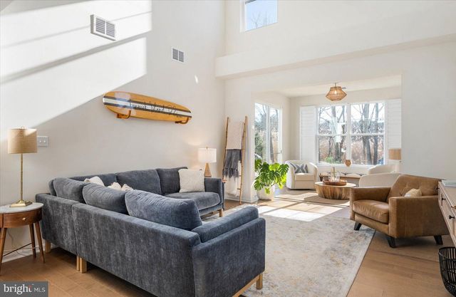 a living room with furniture a couch and a potted plant