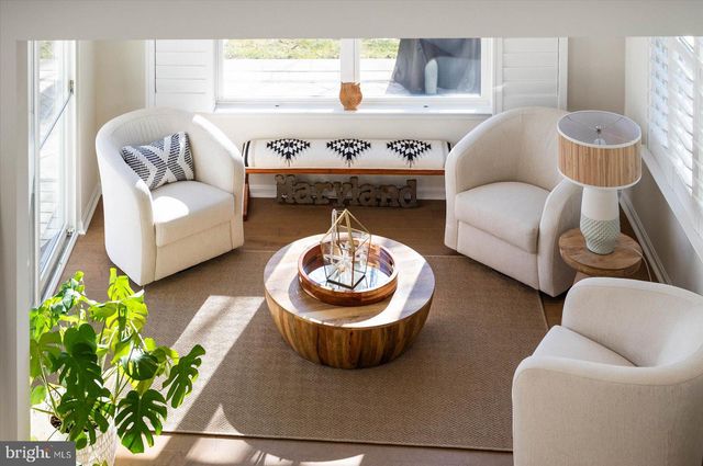 a kitchen with white cabinets and sink