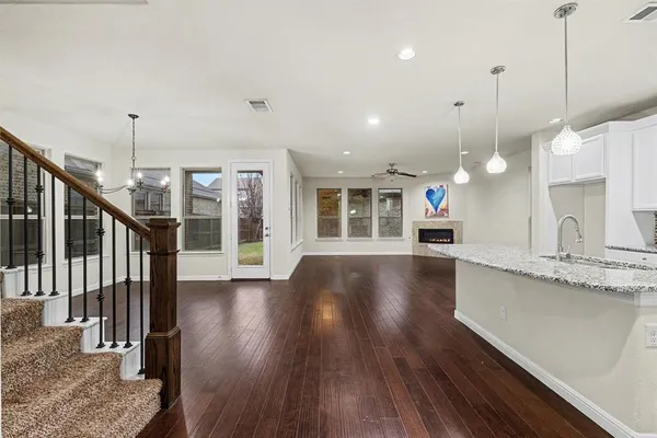 a view of a kitchen and wooden floor