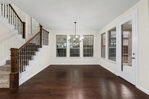 a view of an entryway with wooden floor and door