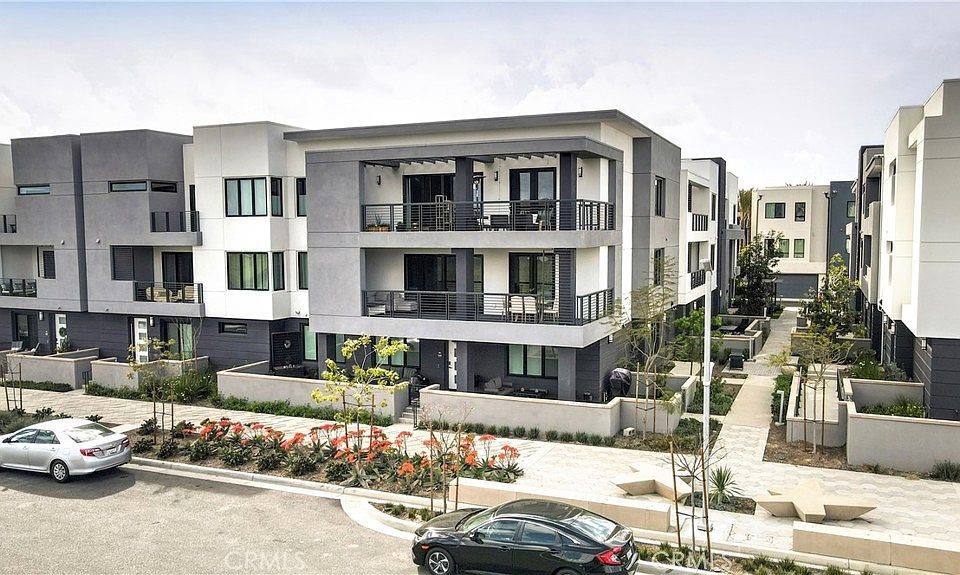 a view of a building with cars parked