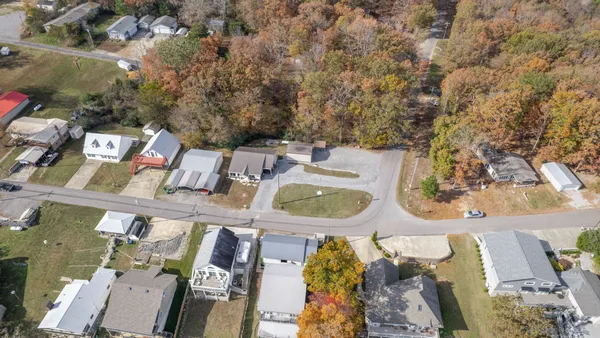 an aerial view of a house with swimming pool and outdoor space