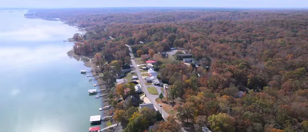 an aerial view of house with yard and mountain view in back