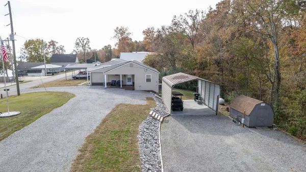 a view of a house with a yard and sitting area