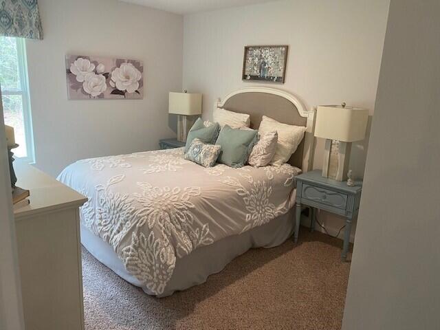 3125 Van Day Way Crestview, FL 32539 - Photo 10 of 24 a bed sitting in a bedroom next to a window