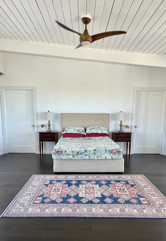 a living room with furniture a flat screen tv and a window