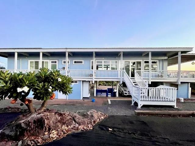 a kitchen with large windows and refrigerator