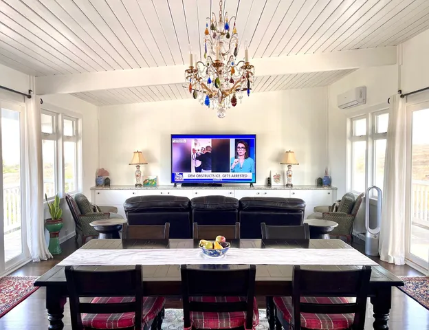 a bedroom with a bed and a couch with wooden floor