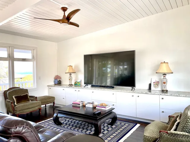 a view of a house with swimming pool and sitting area