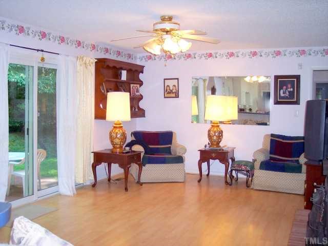 6500 Johnsdale Road Raleigh, NC 27615 - Photo 3 of 7 a living room with furniture and a chandelier
