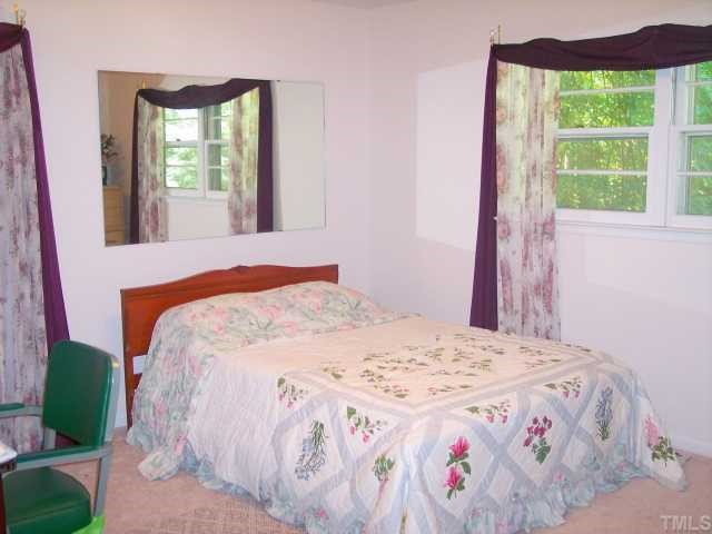 6500 Johnsdale Road Raleigh, NC 27615 - Photo 6 of 7 a bedroom with a bed and a window