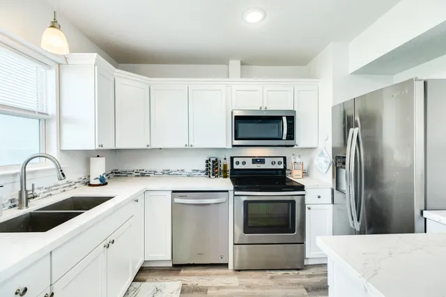 a kitchen with a sink cabinets and window
