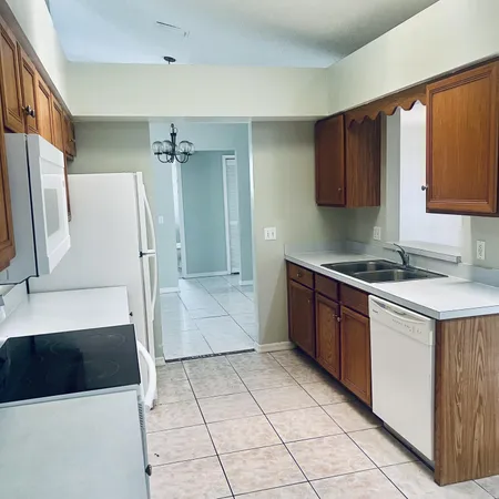a kitchen with stainless steel appliances a stove a microwave and white cabinets