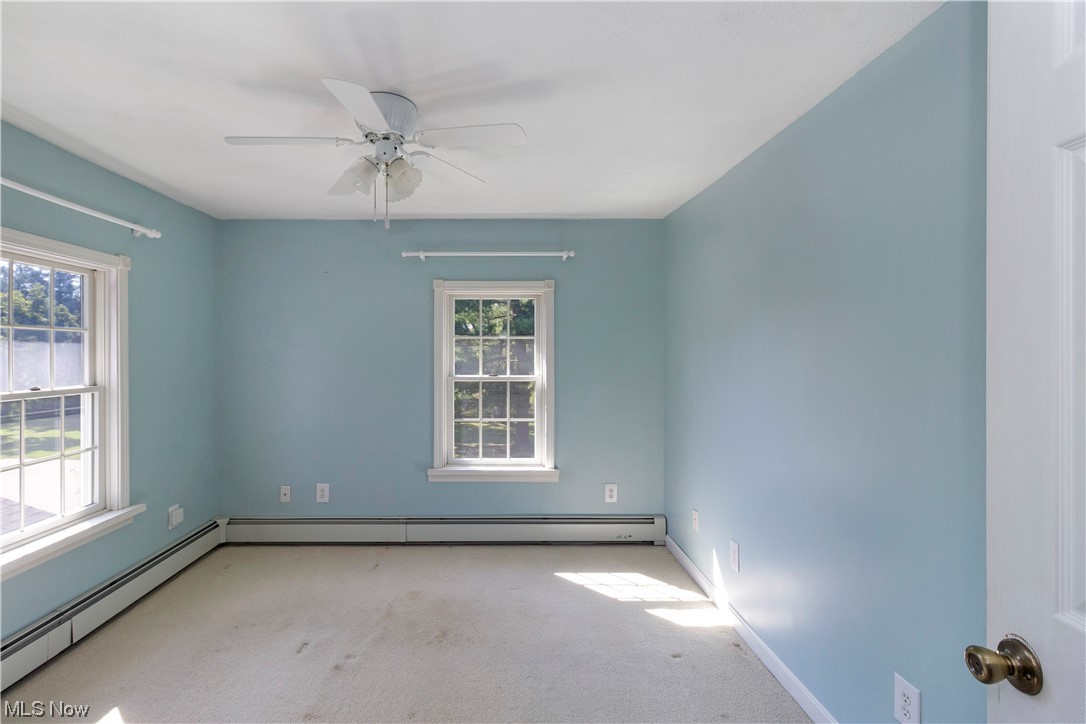 1224 Remsen Road Medina, OH 44256 - Photo 20 of 33 Bedroom with baseboard heating, a wealth of natural light, light carpet, and ceiling fan