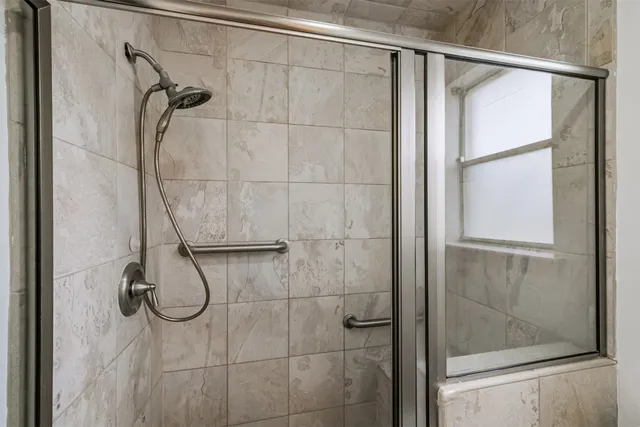a bathroom with a glass shower door