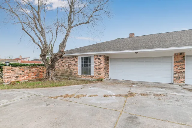 a view of a house with a yard and garage