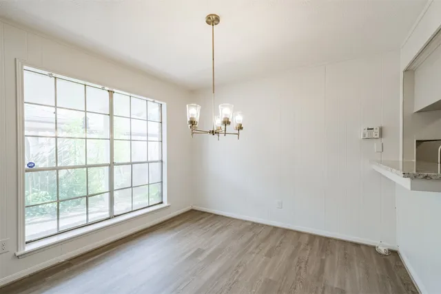 a view of a room with wooden floor and a window