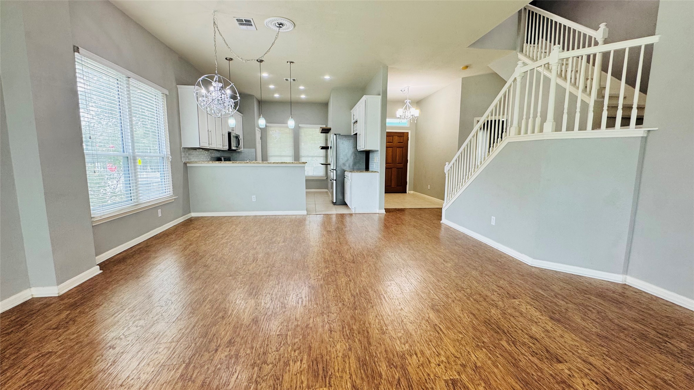 401 Witte Road Kyle, TX 78640 - Photo 4 of 24 An open concept living area features resilient flooring and a clear sightline to the kitchen.