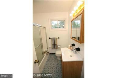 12924 Georgia Avenue Silver Spring, MD 20906 - Photo 15 of 19 a bathroom with a sink a mirror and a toilet