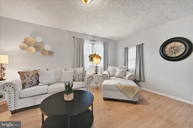a dining room with furniture potted plants and wooden floor