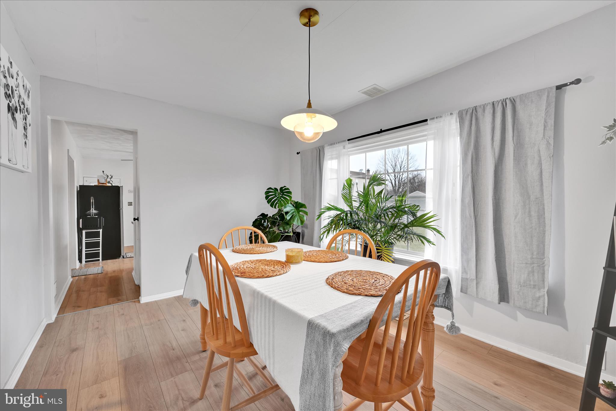 1428 Meade Street Reading, PA 19607 - Photo 13 of 29 a dining room with furniture potted plants and wooden floor
