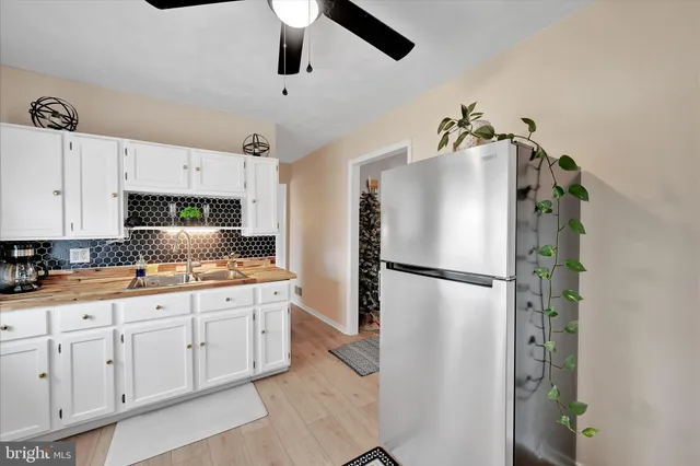 a kitchen with stainless steel appliances granite countertop a stove and a refrigerator