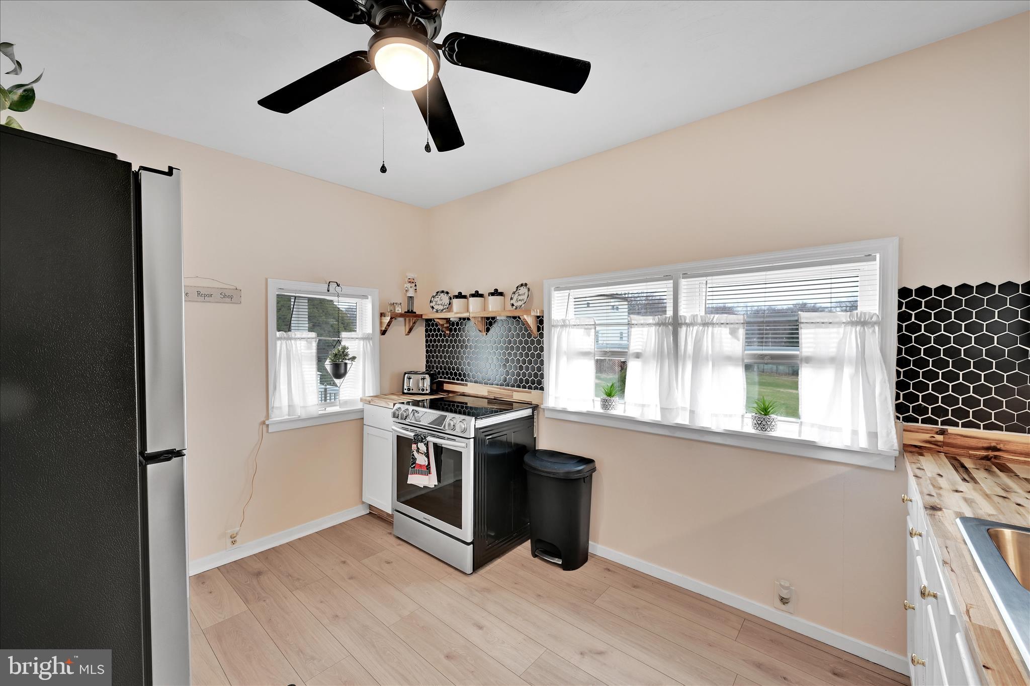 1428 Meade Street Reading, PA 19607 - Photo 17 of 29 a kitchen with stainless steel appliances granite countertop a stove and a refrigerator
