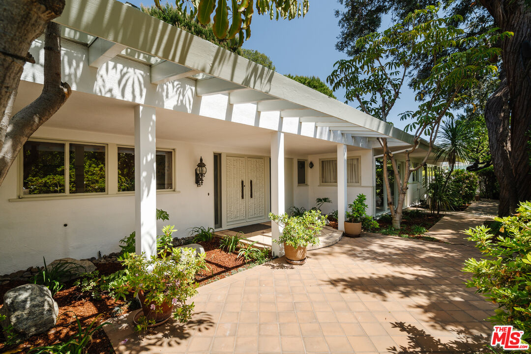 a front view of a house with a yard outdoor seating area and flowers