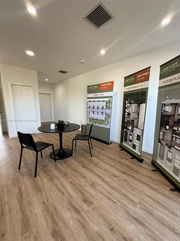 a utility room with a sink a mirror and a window