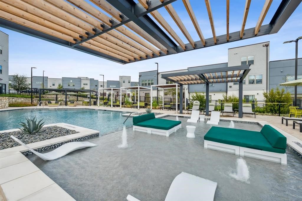 10350 Blue Bluff Road, Unit 6107 Austin, TX 78724 - Photo 25 of 27 a view of a swimming pool with outdoor seating and plants