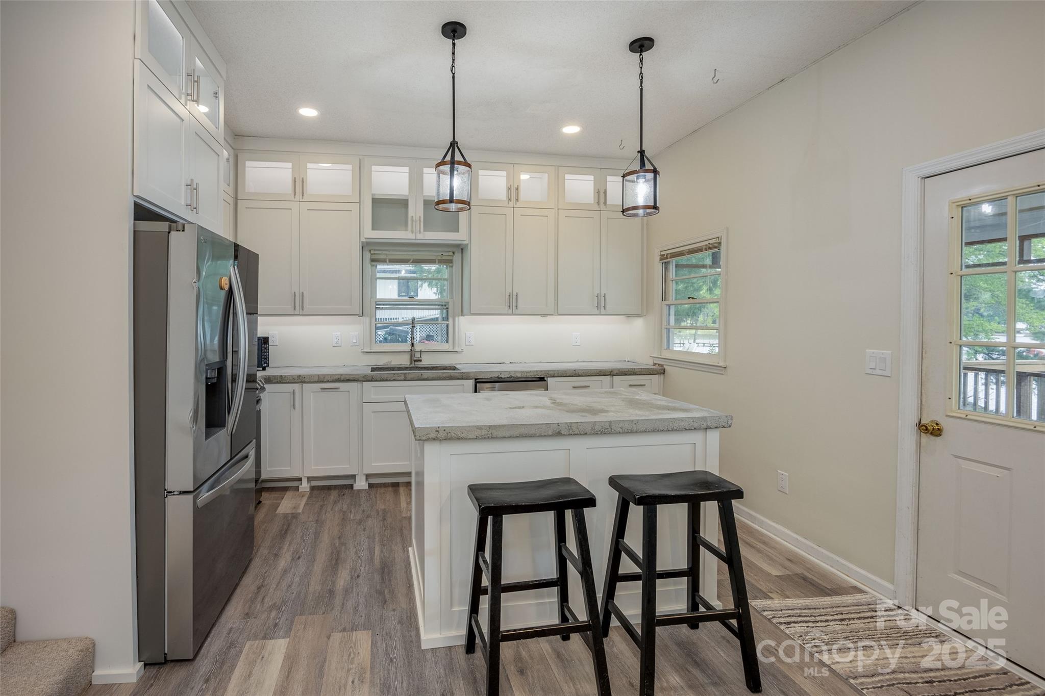 1805 Lake Shore Road Camden, SC 29020 - Photo 17 of 48 a kitchen with kitchen island granite countertop wooden floor cabinets and refrigerator