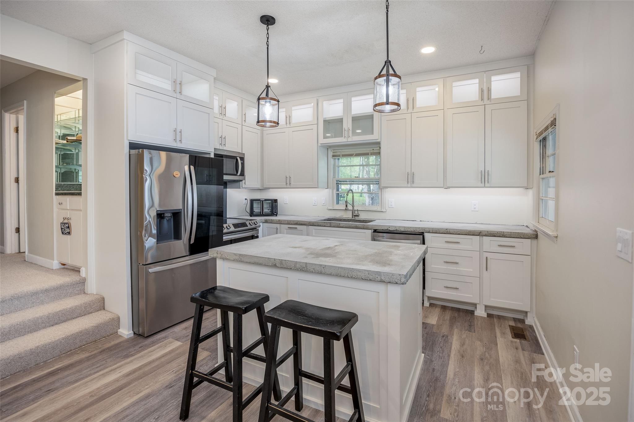 1805 Lake Shore Road Camden, SC 29020 - Photo 18 of 48 a kitchen with kitchen island white cabinets and stainless steel appliances