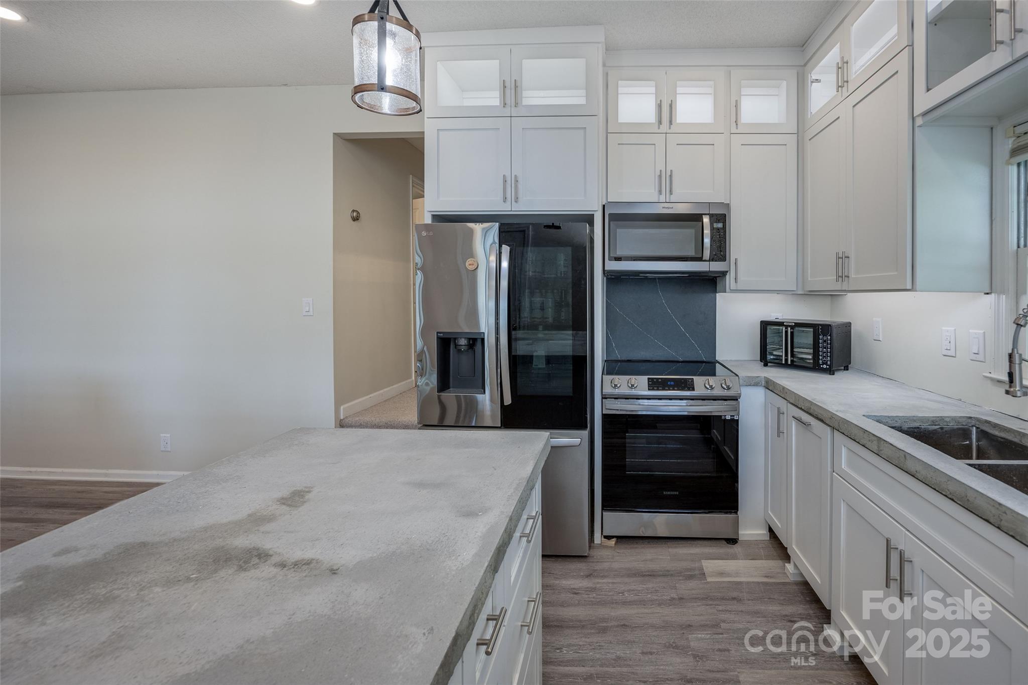 1805 Lake Shore Road Camden, SC 29020 - Photo 19 of 48 a kitchen with stainless steel appliances granite countertop a stove and a refrigerator