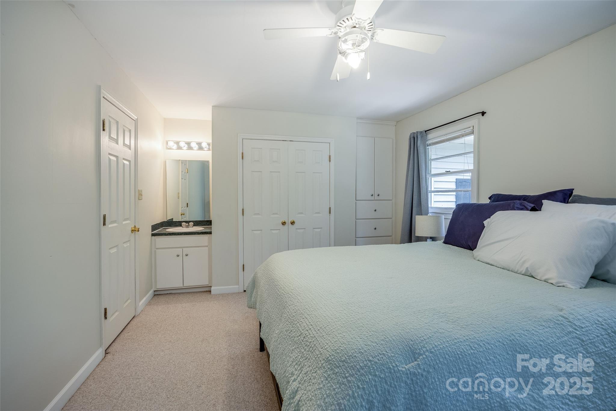 1805 Lake Shore Road Camden, SC 29020 - Photo 24 of 48 a bedroom with a large bed and a chandelier